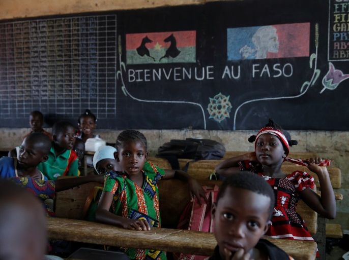 Pupils wait for the French President to enter their classroom during a visit at a school in Ouagadougou, Burkina Faso, November 28, 2017. REUTERS/Philippe Wojazer