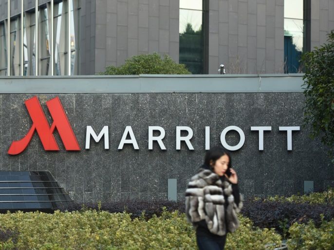 A woman on a mobile phone walks past a Marriott hotel in Hangzhou, Zhejiang province, China January 11, 2018. Picture taken January 11, 2018. REUTERS/Stringer ATTENTION EDITORS - THIS IMAGE WAS PROVIDED BY A THIRD PARTY. CHINA OUT.