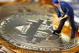 A small toy figure is seen on representations of the Bitcoin virtual currency in this illustration picture, December 26, 2017. REUTERS/Dado Ruvic/Illustration
