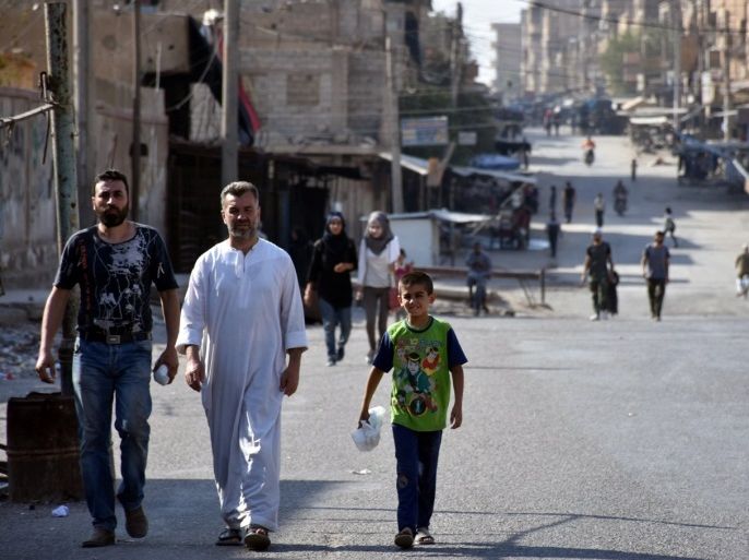 People walk along a street in Deir al Zor, Syria in this handout picture provided by SANA on September 11, 2017. SANA/Handout via REUTERS ATTENTION EDITORS - THIS PICTURE WAS PROVIDED BY A THIRD PARTY. REUTERS IS UNABLE TO INDEPENDENTLY VERIFY THE AUTHENTICITY, CONTENT, LOCATION OR DATE OF THIS IMAGE.