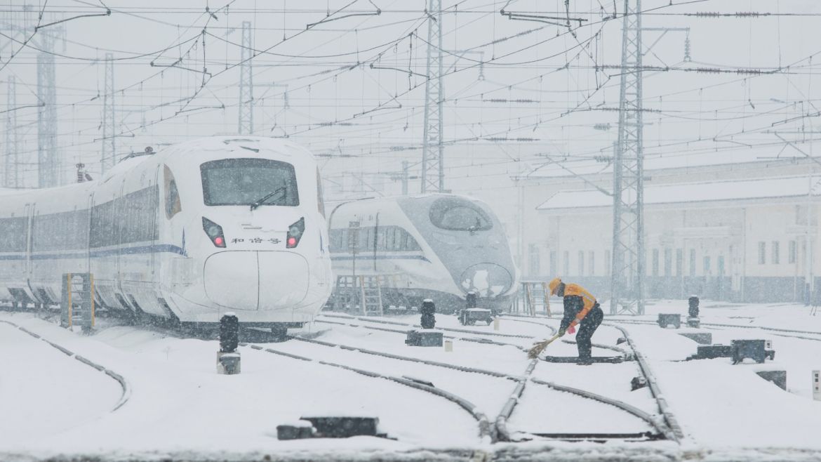 A worker removes snow from railways of high-speed train service in Xi'an, Shaanxi province, China January 6, 2018. Picture taken January 6, 2018. REUTERS/Stringer ATTENTION EDITORS - THIS IMAGE WAS PROVIDED BY A THIRD PARTY. CHINA OUT.