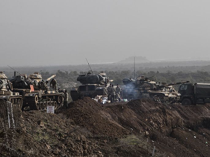 epa06463972 Turkish soldiers prepare their tanks before crossing the Syrian-Turkish border, at the Hassa district on the Turkish-Syrian border in Hatay, Turkey, 22 January 2018. According to media reports, the Turkish army is preparing to conduct an operation (named 'Operation Olive Branch') in Syria's northern regions against the Kurdish Popular Protection Units (YPG) forces which control the city of Afrin. According to YPG media channels, bombings by the Turkish military killed at least 10 people earlier on the same day. Turkey classifies the YPG as a terrorist organization. EPA-EFE/SEDAT SUNA