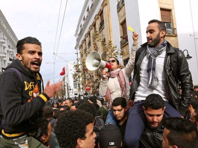 Demonstrating graduate students shout slogans, as riot police stand guard, during protests against rising prices and tax increases, in Tunis, Tunisia January 12, 2018. REUTERS/Zoubeir Souissi