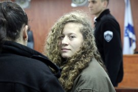 Palestinian teen Ahed Tamimi (R) enters a military courtroom escorted by Israeli Prison Service personnel at Ofer Prison, near the West Bank city of Ramallah, January 1, 2018. REUTERS/Ammar Awad