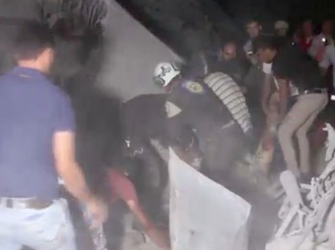 A still image taken from a video obtained by Reuters shows civilians and Civil Defence members searching for people among debris in Idlib, Syria September 29, 2017 . REUTERS TV/via Reuters