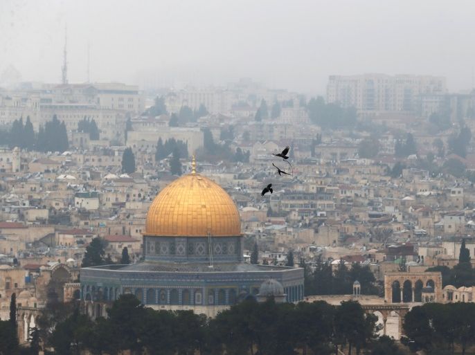 Birds fly on a foggy day near the Dome of the Rock, located in Jerusalem's Old City on the compound known to Muslims as Noble Sanctuary and to Jews as Temple Mount, Jerusalem, January 2, 2018. REUTERS/Ammar Awad