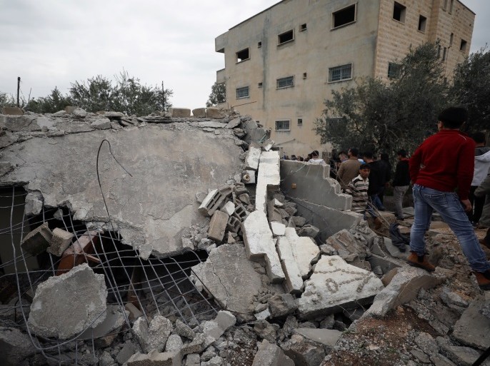 Palestinians check the damage where Israeli forces killed Palestinian gunman Ahmad Nasr Jarrar in Yamoun in the occupied West Bank, February 6, 2018. REUTERS/Mohamad Torokman