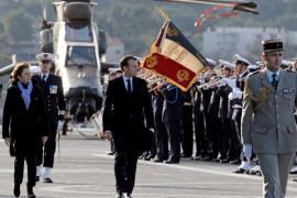 French President Emmanuel Macron and French Defence Minister Florence Parly (L) review troops before delivering New Year wishes to the Armed Forces on the French war ship Dixmude at the Naval base in Toulon, France, January 19, 2018. REUTERS/Jean-Paul Pelissier
