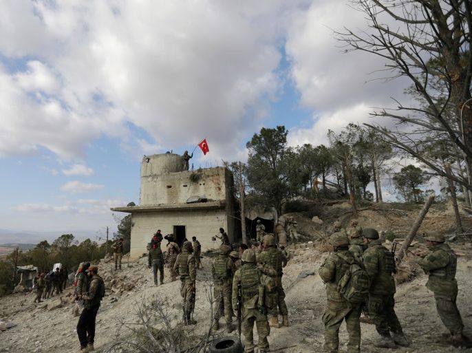 Turkish forces wave a flag on Mount Barsaya, northeast of Afrin, Syria January 28, 2018. REUTERS/ Khalil Ashawi
