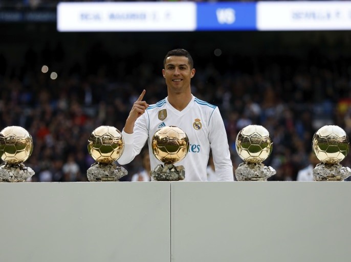 MADRID, SPAIN - DECEMBER 09: Cristiano Ronaldo of Real Madrid CF poses with his five Golden Ball (Ballon d'Or) trophies prior to start the La Liga match between Real Madrid CF and Sevilla FC at Estadio Santiago Bernabeu on December 9, 2017 in Madrid, Spain . (Photo by Gonzalo Arroyo Moreno/Getty Images)