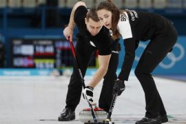 Curling – Pyeongchang 2018 Winter Olympics – Mixed Doubles Bronze Medal Match - Olympic Athletes from Russia v Norway - Gangneung Curling Center - Gangneung, South Korea – February 13, 2018 - Alexander Krushelnitsky and Anastasia Bryzgalova, Olympic athletes from Russia, sweep. Picture taken February 13, 2018. REUTERS/Cathal McNaughton