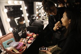 epa05871958 A makeup artist puts a make up for a model to get ready backstage before presenting creations from the Tom Dong Collection as part of the Asahi Kasei Chinese Fashion Designer Creativity Award at the Mercedes-Benz China Fashion Week in Beijing, China, 26 March 2017. The fashion week runs from 24 March to 01 April 2017. EPA/WU HONG