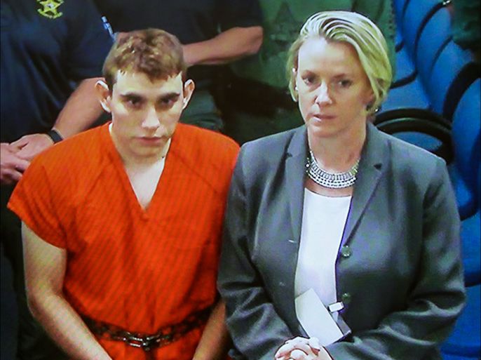 epa06530199 Suspected school shooter Nikolas Cruz (L) stands with assistant public defender Melisa McNeill (R) as he makes a video appearance in Broward County court before Judge Kim Theresa Mollica in Fort Lauderdale, Florida, USA, 15 February 2018. Cruz is facing 17 charges of premeditated murder in the mass shooting at Marjory Stoneman Douglas High School in Parkland, Florida. EPA-EFE/SUSAN STOCKER / POOL RECROP