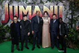 Director Jake Kasdan and cast members Nick Jonas, Dwayne Johnson, Karen Gillan, Jack Black and Kevin Hart pose for photographers as they arrive for the UK premiere of 'Jumanji: Welcome to the Jungle', at the Vue West End, Leicester Square, central London, Britain December 7, 2017. REUTERS/Simon Dawson