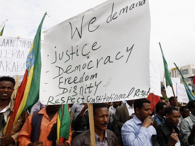 People attend a demonstration organized by opposition party the Ethiopian Federal Democratic Unity Forum (MEDREK) in Ethiopia's capital of Addis Ababa, May 24, 2014. They are protesting against security forces who shot at students who rallied peacefully more than two weeks ago in Oromo, according to organizers. REUTERS/Tiksa Negeri (ETHIOPIA - Tags: CIVIL UNREST POLITICS)