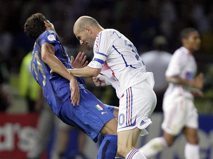 Italy's Marco Materazzi falls on the pitch after being head-butted by France's Zinedine Zidane (R) during their World Cup 2006 final soccer match in Berlin in this July 9, 2006 file photo. France captain Zinedine Zidane was sent off in extra time after headbutting Italy's Marco Materazzi in the Berlin World Cup soccer final with the score tied at 1-1. Materazzi had levelled the score after Zidane scored the opening goal from a penalty. Italy went on to win the penalty shootout 5-3. Picture taken July 9, 2006. To match feature -DECADE/TIMELINE HOLLAND OUT REUTERS/Peter Schols/GPD/Handout (SPORT SOCCER)