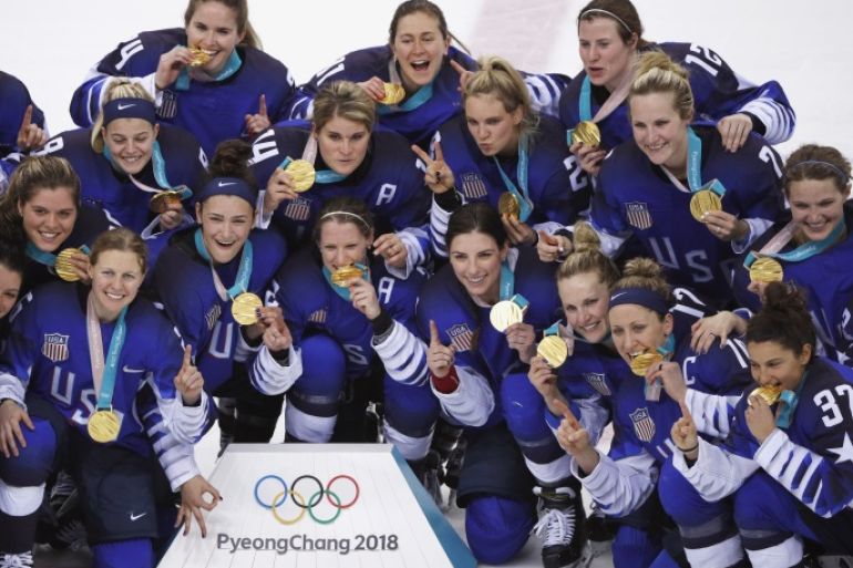 Ice Hockey - Pyeongchang 2018 Winter Olympics - Women's Gold Medal Final Match - Canada v USA - Gangneung Hockey Centre, Gangneung, South Korea - February 22, 2018 - Team USA players hold up their gold medals as they pose after winning their game. REUTERS/Brian Snyder