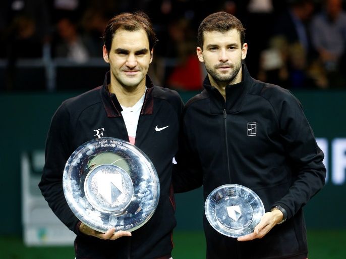 Tennis - ATP 500 - Rotterdam Open - Final - Ahoy , Rotterdam, Netherlands - February 18, 2018 - Roger Federer of Switzerland and Grigor Dimitrov of Bulgaria hold their trophies. REUTERS/Michael Kooren