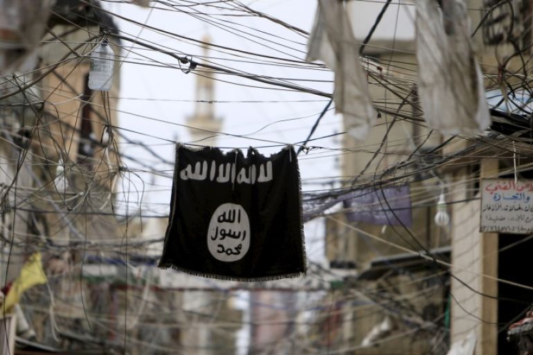 An Islamic State flag hangs amid electric wires over a street in Ain al-Hilweh Palestinian refugee camp, near the port-city of Sidon, southern Lebanon January 19, 2016. REUTERS/Ali Hashisho