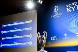 epa06607771 The match fixtures are displayed on an electronic panel next to the Champions League trophy following the draw of the UEFA Champions League 2017/18 quarter final soccer matches at the UEFA Headquarters in Nyon, Switzerland, 16 March 2018. EPA-EFE/JEAN-CHRISTOPHE BOTT