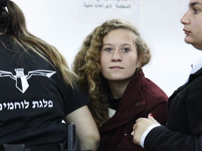 epa06618548 (FILE) - Palestinian teenager Ahed Tamimi (C) appears at a military court at the Israeli-run Ofer prison in the West Bank village of Betunia, 20 December 2017 (reissued 21 March 2018). According to reports, prescutors and lawyers for Tamimi on 21 March 2018 reached a deal that would have Tamimi serve a prison sentence of eight months. Tamimi, 17, was arrested on 19 December 2017 by the Israeli army after a video was posted of her slapping Israeli soldiers in