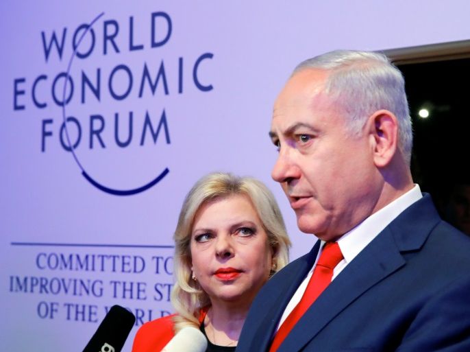 Israel's Prime Minister Benjamin Netanyahu talks to the media next to his wife Sara during the World Economic Forum (WEF) annual meeting in Davos, Switzerland January 25, 2018. REUTERS/Denis Balibouse