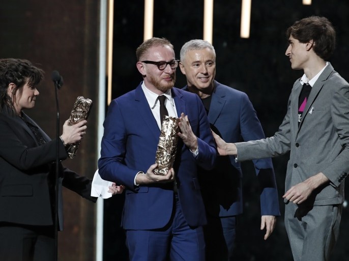 43rd Cesar Awards ceremony - Paris, France. 03/03/2018. French film producers Hugues Charbonneau and Marie-Ange Luciani, Remy Hamai, president of Act Up and French director Robin Campillo react after winning the Best FIlm Cesar for their film