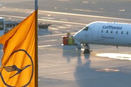 A plane by Lufthansa is seen next to a Lufthansa flag at the international airport in Munich, Germany, January 9, 2018. REUTERS/Michaela Rehle