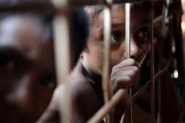 Rohingya refugee child looks through the fence at a refugee camp in Cox's Bazar, Bangladesh March 22, 2018. REUTERS/Mohammad Ponir Hossain