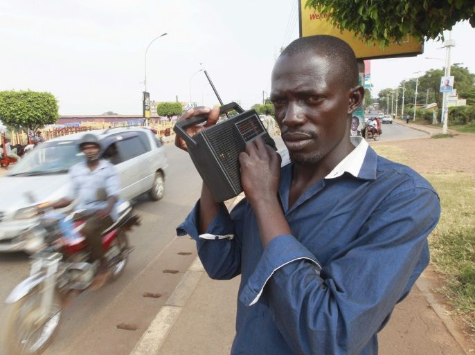 A man listens to election results on his FM radio in Uganda's capital Kampala, February 19, 2016. Ugandan police shot in the air and fired tear gas at opposition protesters in several parts of southern Kampala on Friday, a Reuters witness said, after the presidential election a day earlier. REUTERS/James Akena