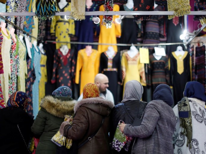Visitors buy women's clothes during the 35th annual meeting of French Muslims (RAMF), the cultural and festive event organized by the Union of Islamic Organizations of France (UOIF) at Le Bourget, near Paris, France, March 30, 2018. REUTERS/Gonzalo Fuentes