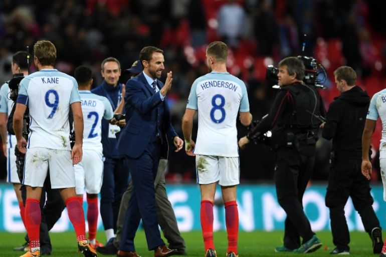 LONDON, ENGLAND - OCTOBER 05: Gareth Southgate, manager of England and Jordan Henderson of England celebrate victory and World Cup Finals qualification after the FIFA 2018 World Cup Group F Qualifier between England and Slovenia at Wembley Stadium on October 5, 2017 in London, England. (Photo by Laurence Griffiths/Getty Images)