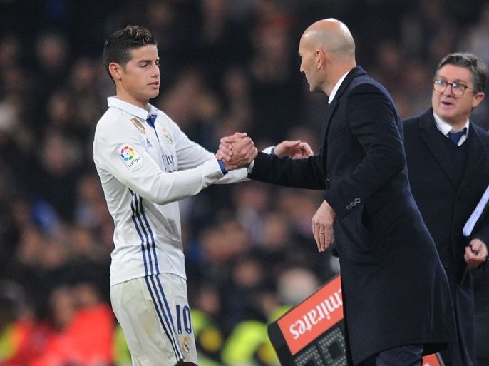 MADRID, SPAIN - JANUARY 04: James Rodriguez of Real Madrid shakes hands with his manager Zinedine Zidane after being substituted during the Copa del Rey Round of 16 First Leg match between Real Madrid and Sevilla at Bernabeu on January 4, 2017 in Madrid, Spain. (Photo by Denis Doyle/Getty Images)