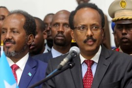 Somalia's newly elected President Mohamed Abdullahi Farmajo flanked by outgoing president Hassan Sheikh Mohamud (L) addresses lawmakers after winning the vote at the airport in Somalia's capital Mogadishu, February 8, 2017. REUTERS/Feisal Omar