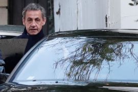 Former French President Nicolas Sarkozy enters his car as he leaves his house in Paris, France, March 21, 2018. REUTERS/Benoit Tessier
