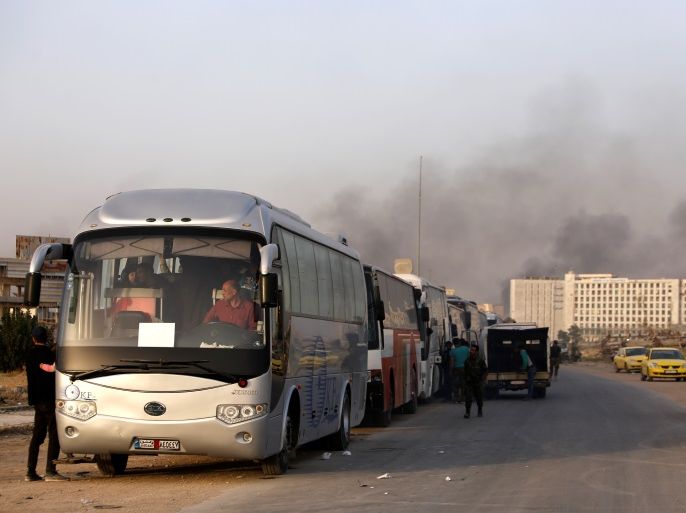 A convoy of buses that carry rebels and their families waits at Harasta highway outside Jobar, in Damascus, Syria March 26, 2018. REUTERS/Omar Sanadiki