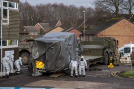 SALISBURY, ENGLAND - MARCH 10: Military personnel wearing protective suits load an ambulance on to a truck as they prepare to remove it from Salisbury ambulance station as they continue investigations into the poisoning of Sergei Skripal on March 10, 2018 in Salisbury, England. Sergei Skripal who was granted refuge in the UK following a 'spy swap' between the US and Russia in 2010 and his daughter remain critically ill after being attacked with a nerve agent. (Photo