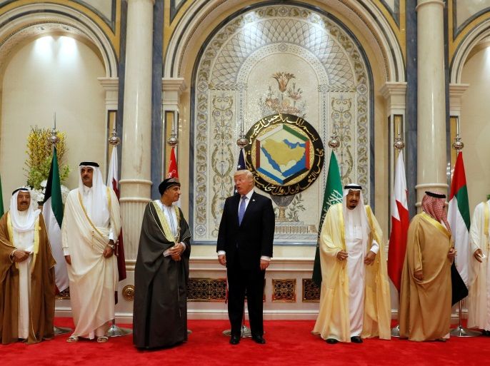 U.S. President Donald Trump (4-L) speaks with Oman's Deputy Prime Minister Fahd bin Mahmoud Al-Said (3-L) during a family photo with Gulf Cooperation Council leaders at their summit in Riyadh, Saudi Arabia May 21, 2017. REUTERS/Jonathan Ernst