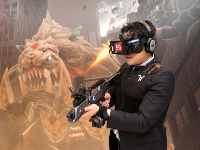 A man plays Special Force VR Universal War, the world's first multi-player VR Game with 5G technology, inside Korean Telecom (KT) booth at the Mobile World Congress in Barcelona, Spain, February 28, 2018. REUTERS/Sergio Perez