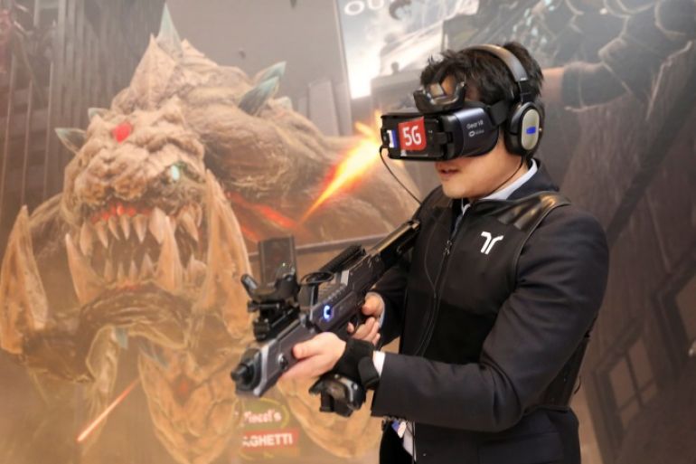A man plays Special Force VR Universal War, the world's first multi-player VR Game with 5G technology, inside Korean Telecom (KT) booth at the Mobile World Congress in Barcelona, Spain, February 28, 2018. REUTERS/Sergio Perez