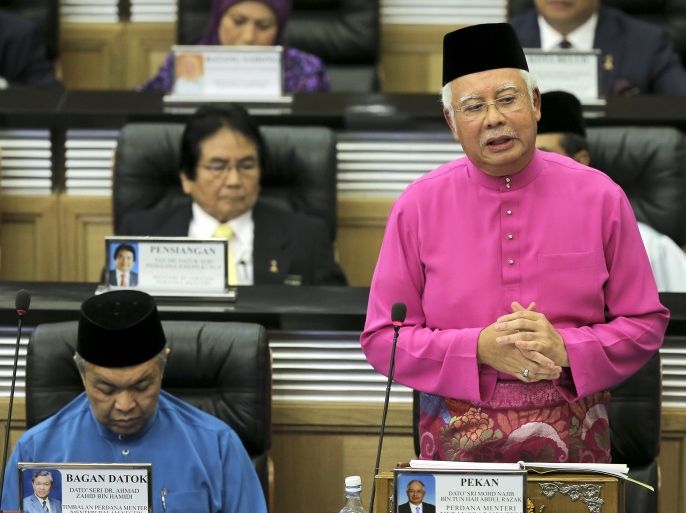 Malaysian Prime Minister Najib Abdul Razak (R) speaks to members of the Parliament during the 2017 Budget presentation