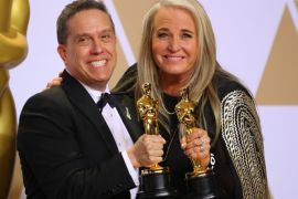 90th Academy Awards - Oscars Backstage - Hollywood, California, U.S., 04/03/2018 - Lee Unkrich (L) and Darla K. Anderson hold their Oscars for Best Animated Feature Film "Coco". REUTERS/Mike Blake