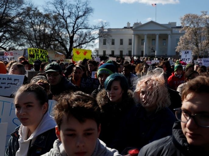 Hundreds of students sit for 17 minutes of silence to honor the victims of the recent shooting at Florida's Marjory Stoneman Douglas High School, as they take part in the national school walkout to demand stricter gun control, outside the White House in Washington, U.S., March 14, 2018. REUTERS/Leah Millis