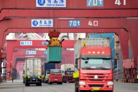 Trucks transport containers at Qingdao port in Shandong province, China March 8, 2018. China Daily via REUTERS ATTENTION EDITORS - THIS IMAGE WAS PROVIDED BY A THIRD PARTY. CHINA OUT.