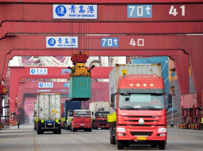 Trucks transport containers at Qingdao port in Shandong province, China March 8, 2018. China Daily via REUTERS ATTENTION EDITORS - THIS IMAGE WAS PROVIDED BY A THIRD PARTY. CHINA OUT.