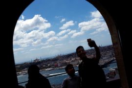 Tourists pose for a selfie with the old city in the background, at Galata tower in Istanbul, Turkey, August 1, 2017. REUTERS/Murad Sezer