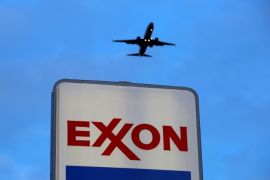 An airplane comes in for a landing above an Exxon sign at a gas station in the Chicago suburb of Norridge, Illinois, U.S., October 27, 2016. REUTERS/Jim Young