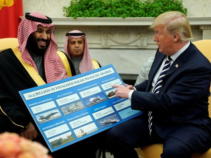 U.S. President Donald Trump holds a chart of military hardware sales as he welcomes Saudi Arabia's Crown Prince Mohammed bin Salman in the Oval Office at the White House in Washington, U.S., March 20, 2018. REUTERS/Jonathan Ernst