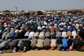 Palestinians perform Friday prayers during a protest demanding the right to return to their homeland, at the Israel-Gaza border in the southern Gaza Strip April 6, 2018. REUTERS/Ibraheem Abu Mustafa