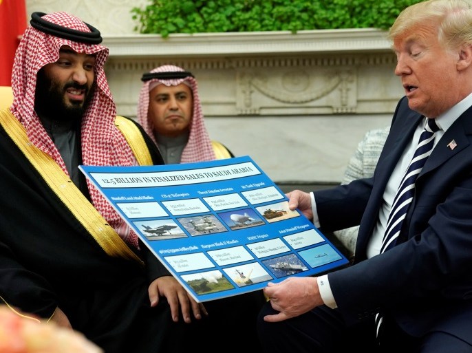U.S. President Donald Trump holds a chart of military hardware sales as he welcomes Saudi Arabia's Crown Prince Mohammed bin Salman in the Oval Office at the White House in Washington, U.S. March 20, 2018. REUTERS/Jonathan Ernst